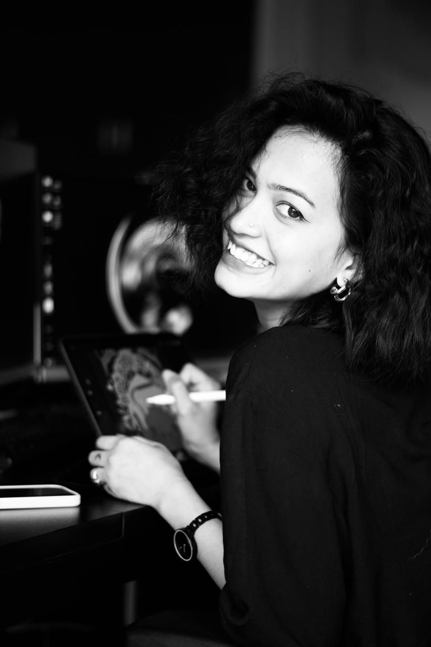 A man in a brown sweater is sitting down.